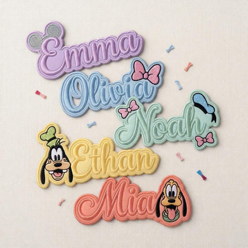May include: Embroidered name patches in pastel colors, featuring names like Emma, Olivia, Noah, Ethan, and Mia. Each patch has a Disney character design, including Mickey Mouse, Minnie Mouse, Goofy, and Pluto. Ideal for personalizing clothing or accessories.