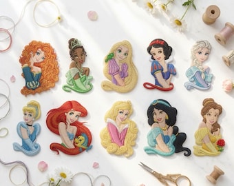 May include: A collection of ten embroidered patches featuring various animated female characters with distinct hair colors, clothing styles, and expressions, arranged in two rows on a white surface alongside sewing supplies and white flowers.