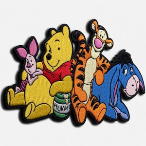 May include: An embroidered patch featuring Piglet, Winnie the Pooh holding a green pot labeled Hunny, Tigger, and Eeyore. The characters are rendered in bright yellow, red, orange, black, and blue thread with a black border on a white background.