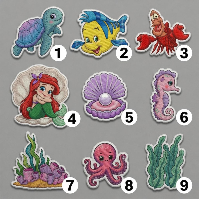 May include: A collection of nine embroidered patches featuring aquatic themes, including a sea turtle, a yellow and blue fish, a red crab, a mermaid in a shell, a pearl in a purple shell, a pink seahorse, coral with seaweed, an octopus, and green seaweed.