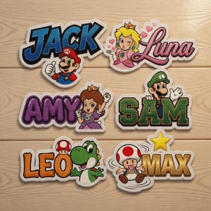 May include: Embroidered patches featuring characters and names from the Super Mario video game series. The patches include names like "Jack," "Luna," "Amy," "Sam," "Leo," and "Max," each with a corresponding character illustration. The patches have a white border.