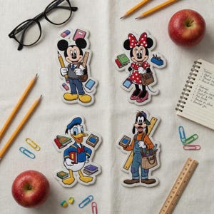 May include: Four Disney character stickers: Mickey Mouse, Minnie Mouse, Donald Duck, and Goofy, each holding school supplies. Pencils, apples, glasses, and a notepad are scattered around the stickers on a white surface.