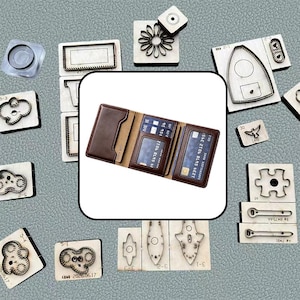 May include: A tri-fold brown leather wallet featuring multiple card slots and a clear identification window, displayed alongside various metal cutting dies used for leather crafting, including shapes like clouds, flowers, and puzzle pieces.