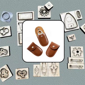 May include: Three brown leather pouches with silver snap closures, one of which is open to reveal a silver metal ring inside. These pouches are surrounded by various wooden-backed metal cutting dies of different shapes, including clouds, flowers, and tools.