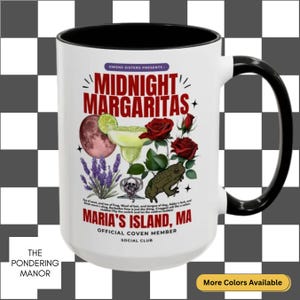 May include: White ceramic mug with a black handle and interior. The mug features the text "MIDNIGHT MARGARITAS" with illustrations of a margarita, roses, a frog, and other elements. The text "MARIA'S ISLAND, MA" is also present.