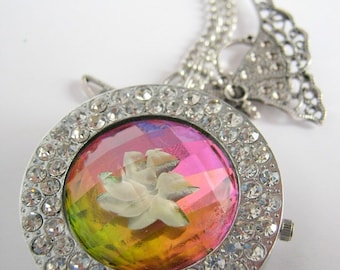 Irridescent flower watch with tibetian style butterfly charm necklace.
