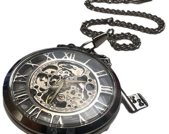 Silver colored Steampunk pocket watch with chain and key charm. Beautiful mechanical watch movement.