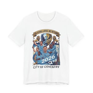 May include: White t-shirt with a graphic of a football team in light blue. The design includes the text "25 YEARS LATER, WE RETURN!" and "2026 CITY OF COVENTRY". The graphic also features lions and a football.
