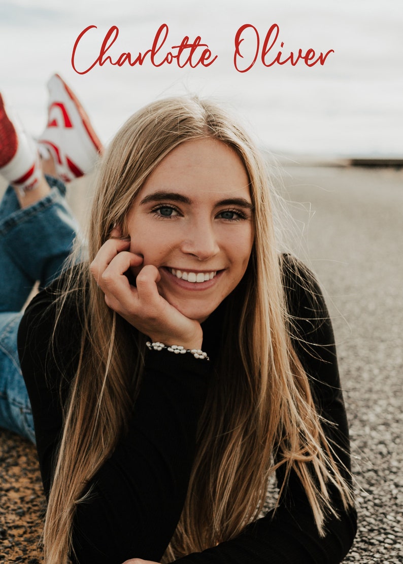 May include: A young woman with long blonde hair is lying on her stomach and smiling at the camera. She is wearing a black long-sleeved shirt and blue jeans. Her red sneakers are visible in the background. The text "Charlotte Oliver" is written in red cursive at the top of the image.