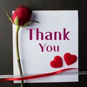 May include: A white card with the words "Thank You" in a deep pink font, accompanied by two red heart-shaped decorations and a red rose. A red ribbon and silver ribbon are also present.