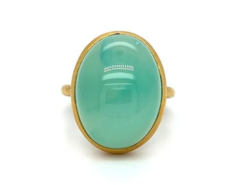 May include: A gold ring with a large oval-shaped light green gemstone.