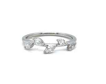 May include: A delicate silver ring with a design of leaves set with small diamonds.