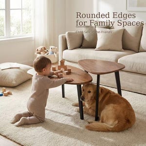 May include: Two nesting coffee tables with dark wood triangular tops and black legs. The text reads: Rounded Edges for Family Spaces, Child-Safe, Pet-Friendly. The tables are positioned on a light-colored rug in a living room setting.