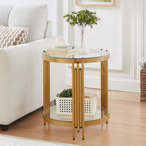 May include: A round side table with a gold-toned metal frame and two circular glass shelves. The table features vertical rod supports and holds a white plastic storage bin on the bottom shelf, with a glass vase of greenery on the top surface.