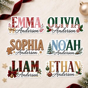 May include: Six rectangular stickers featuring personalized names in festive holiday fonts and patterns. The names Emma, Olivia, Sophia, Noah, Liam, and Ethan are displayed with decorative elements like gingerbread, pine trees, bows, and ornaments.