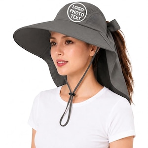 May include: Gray sun hat with a wide brim and neck flap. The hat features a mesh panel for ventilation and a drawstring for adjustment. A white circle with the text "LOGO PHOTO TEXT" is on the top of the hat.