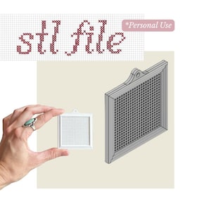 May include: A digital 3D model file for a square cross-stitch frame with a hanging loop. The image displays the text "stl file" and "*Personal Use" in a cross-stitch font style, alongside a small white physical frame and a larger 3D render.
