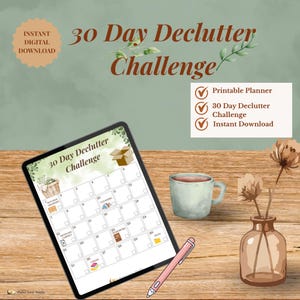 May include: A digital planner for a 30-day declutter challenge. The image shows a tablet displaying a calendar layout with prompts, a pink stylus, a mug, and a vase with dried flowers. Text includes "Instant Digital Download" and "30 Day Declutter Challenge."