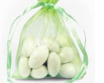 May include: A lime green sheer organza drawstring bag filled with several smooth, oval-shaped white candies. The bag is tied at the top with matching lime green ribbon strings. The text LIME GREEN is printed in gray at the bottom of the image.