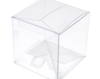May include: A clear, transparent, cube-shaped box with a hinged lid. The box is made of a rigid, see-through plastic material. The box is empty and ready to be filled with a product for display or packaging.