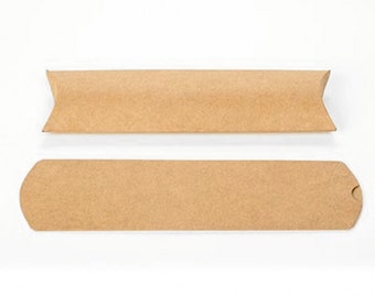 May include: Two brown kraft paper pillow boxes, one assembled and one flat. The assembled box has a rectangular shape with curved ends and a folded top. The flat box is a long rectangle with rounded ends and a small cutout.