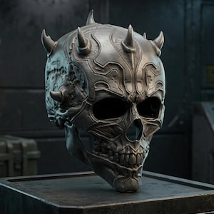 May include: A metallic grey skull sculpture featuring intricate raised patterns and several pointed horn-like protrusions extending from the cranium. The skull has deep, hollow eye sockets and a detailed jawline with visible teeth, presented in a dark finish.