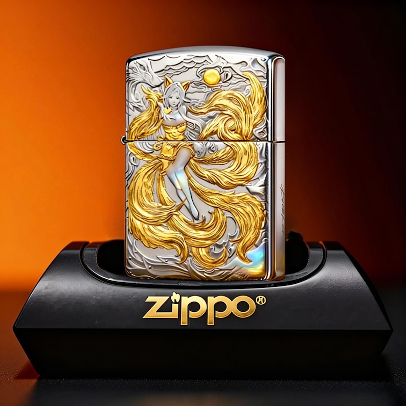 May include: A silver Zippo lighter with a gold and silver embossed design of a mythical figure with flowing hair and tails. The lighter is displayed on a black stand with the Zippo logo in gold.