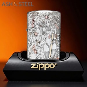 May include: A silver Zippo lighter with an engraved design featuring two anime-style women. The lighter is displayed on a black stand with the Zippo logo in gold. The top of the lighter has an intricate design.