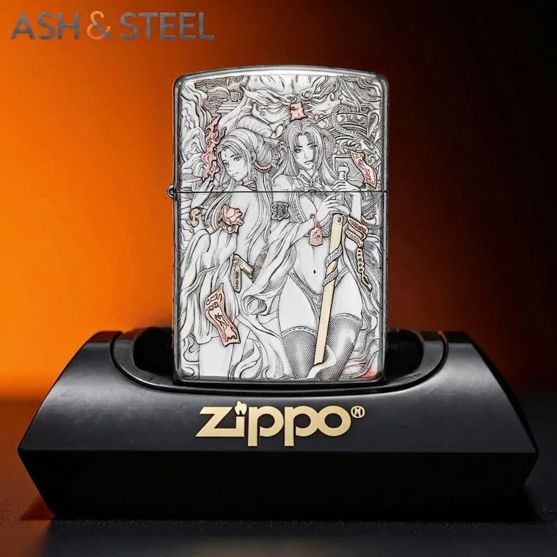 May include: A silver Zippo lighter with an engraved design featuring two anime-style women. The lighter is displayed on a black stand with the Zippo logo in gold. The top of the lighter has an intricate design.
