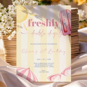 May include: A rectangular birthday invitation card with a yellow and white striped background. It features a pink popsicle, a sun, a pink umbrella, and pink sunglasses. The text reads: freshly double digits, PLEASE JOIN US TO CELEBRATE, Olivia's 10th Birthday, AUG 20 3 PM, THE ELMWOOD ESTATE 88 ROSEWOOD LANE CHARLESTON, SC 29401, RSVP +123 456 7890.