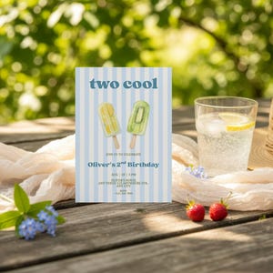 May include: A rectangular birthday invitation card with a light blue and white vertical striped background. The text reads two cool, Join us to celebrate Oliver's 2nd Birthday, Aug 28 | 3 PM, Oliver's House, Any Venue 123 Anywhere Str, Any City, RSVP +123 456 7890.