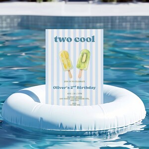May include: A rectangular birthday invitation card with light blue and white vertical stripes. The text reads two cool, Oliver's 2nd Birthday, Aug 20, 3 PM, Oliver's House, Any Venue 123 Anywhere Str, Any City, RSVP +123 456 7890. Features two fruit popsicles.