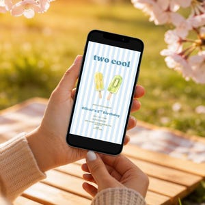 May include: A smartphone screen displaying a digital birthday invitation with a light blue and white striped background. The text reads two cool, Oliver's 2nd Birthday, and includes details for date, time, location, and contact information.