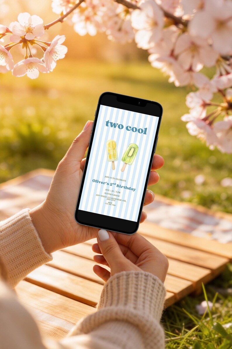 May include: A smartphone screen displaying a digital birthday invitation with a light blue and white striped background. The text reads two cool, Oliver's 2nd Birthday, and includes details for date, time, location, and contact information.