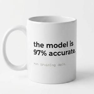 May include: White ceramic mug with a curved handle. The mug features the text "the model is 97% accurate." below which is the text "*on training data." in a smaller font. The mug is set against a white background.