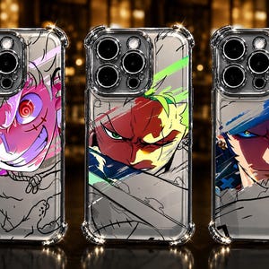 May include: Three clear phone cases featuring anime-style character illustrations. The left case shows a pink-toned character with a wide grin, the centre case displays a green-haired character, and the right case depicts a blue-haired character.