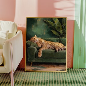 May include: A framed art print depicts a sleeping cheetah on a green velvet sofa. The cheetah has a spotted coat and is resting on a green cushion. The background features a dark green wall and a large plant.