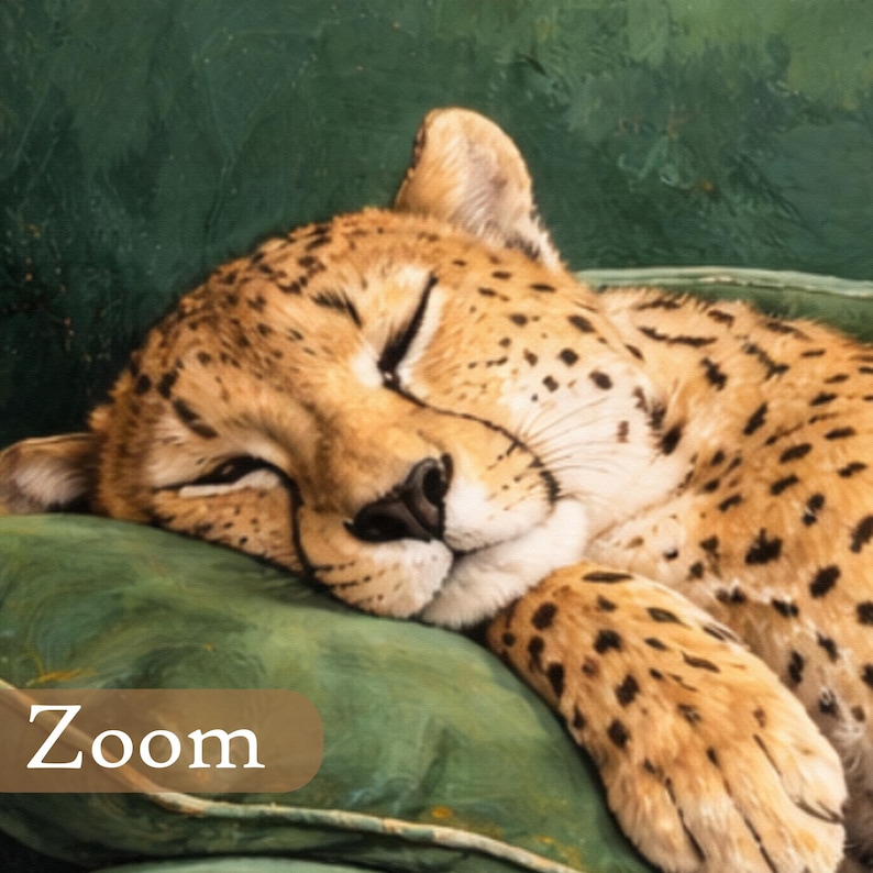 May include: A close-up of a sleeping cheetah with closed eyes, resting on a green pillow. The cheetah has a tan coat with black spots. The word "Zoom" is visible in a brown rectangle at the bottom left.