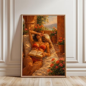 May include: A framed art print depicts a person in a red bikini reclining on a lounge chair, shielding their eyes with one hand while holding a book. The scene is set on a sunlit terrace with potted flowers and a scenic background.