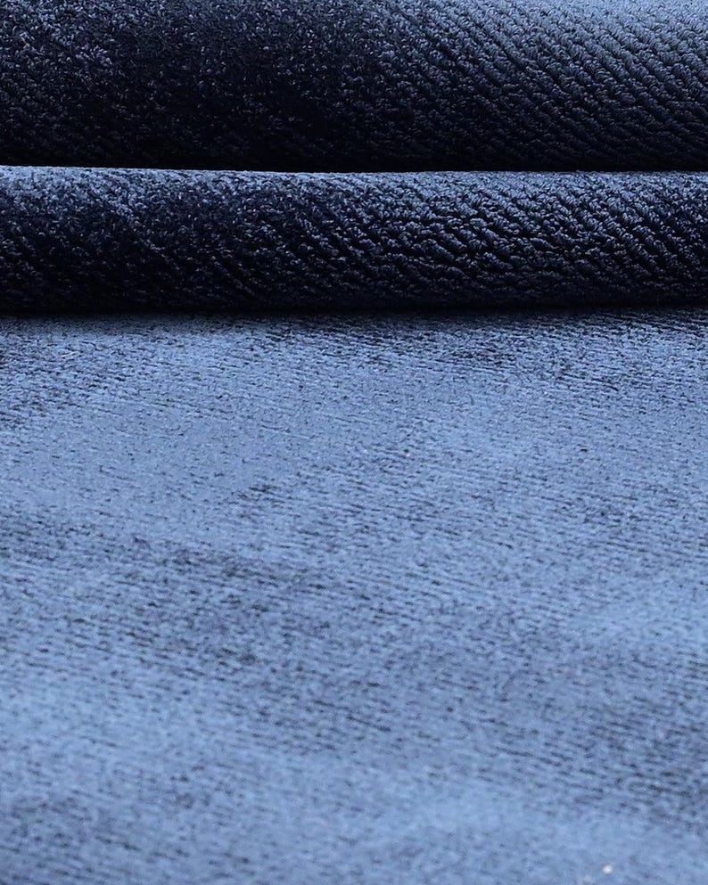 May include: A white ceramic mug with a black handle and the text "But First, Coffee" in a handwritten style. The mug is on a white surface. The mug is approximately 4 inches tall.