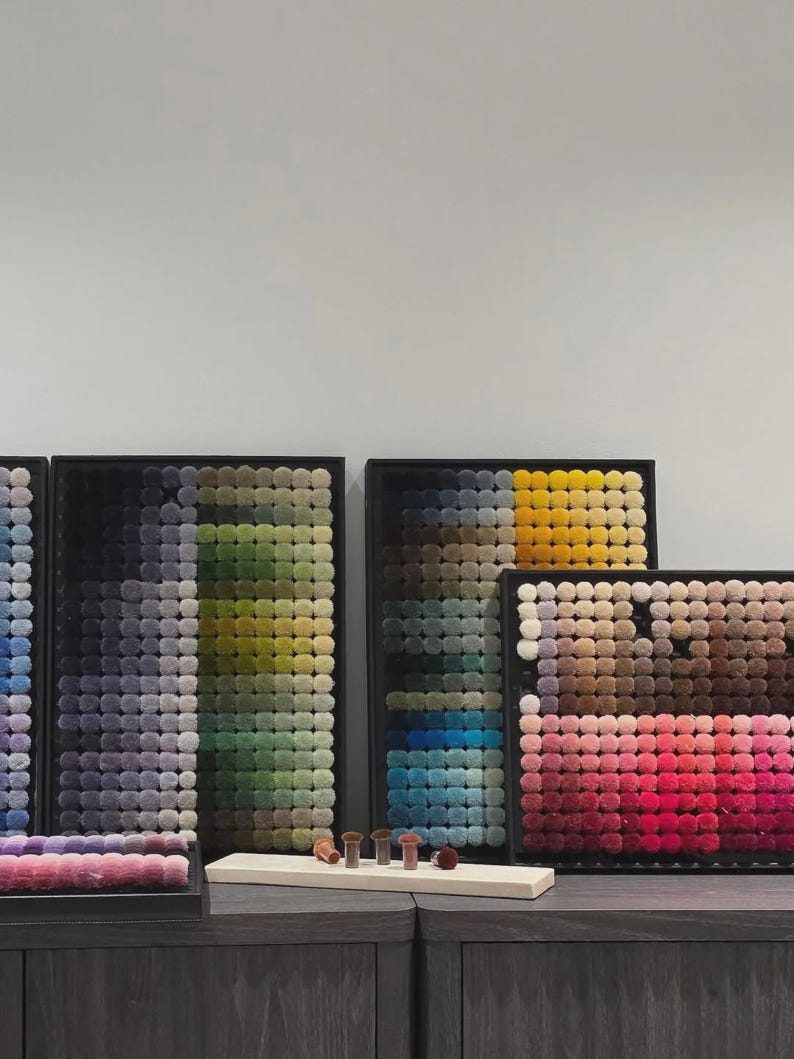 May include: A handmade wooden sign with the text "Welcome" in a whimsical font. The sign is painted white with a distressed finish, and features a decorative floral design in shades of pink and green. It measures approximately 12 inches wide.