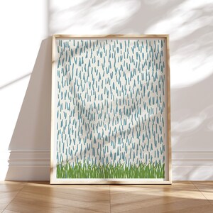 May include: A framed print with a white background and a pattern of blue lines. The bottom of the print features a row of green grass.