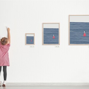 May include: Three framed prints of a minimalist abstract design featuring a red triangle on a blue background with white lines. The prints are in different sizes, with the largest print measuring 25 inches by 31 inches.