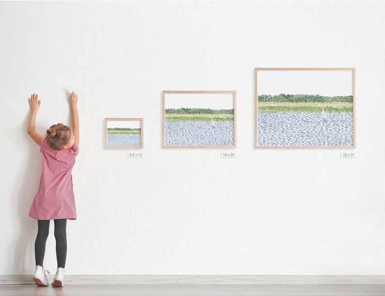 May include: Three framed prints of a watercolor painting of a lake with green trees and a white bird in the distance. The prints are in different sizes, with the smallest print measuring 9.5 x 12 inches, the middle print measuring 18 x 22 inches, and the largest print measuring 25 x 31 inches.