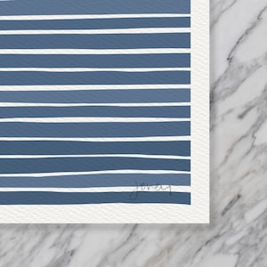 May include: A blue and white striped print with a handwritten signature in the bottom right corner.