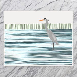 May include: A gray heron with an orange beak stands in a blue and green striped water scene. The heron has a black stripe on its head.
