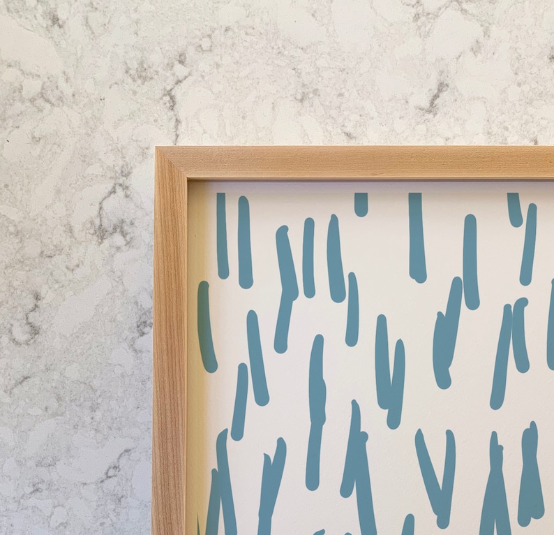 May include: A framed print with a white background and a repeating pattern of blue abstract shapes. The shapes resemble lines and squiggles.