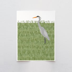 May include: A grey heron with an orange beak stands in a field of green grass.