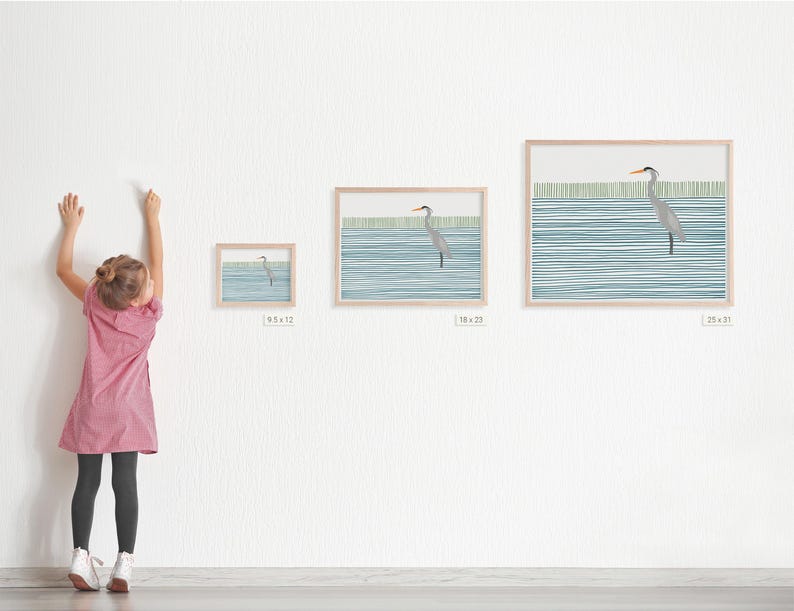 May include: A framed print of a watercolor painting of a heron standing in a body of water with a blue and green striped background. The print is available in three sizes: 6.5 x 12 inches, 18 x 22 inches, and 25 x 31 inches.