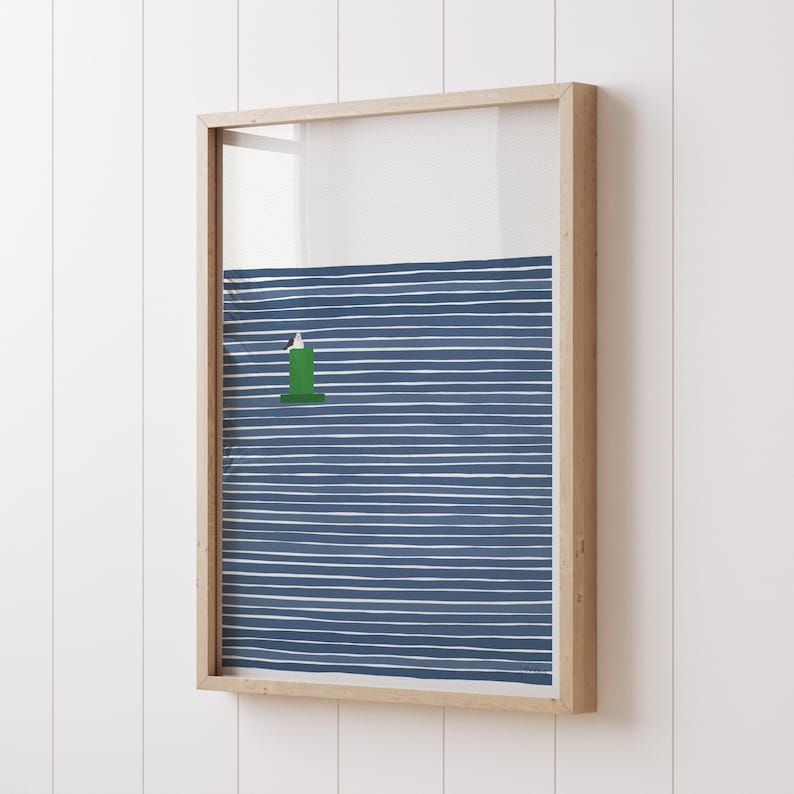 May include: A framed print of a green lighthouse on a blue and white striped background. The lighthouse is in the center of the image and is surrounded by the stripes.